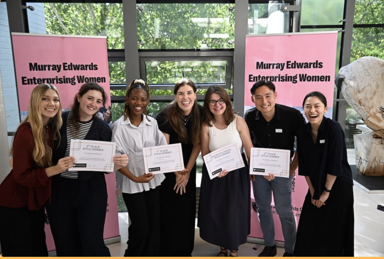Afromics team holding certificates at the Murray Edwards College Enterprising Women Programme