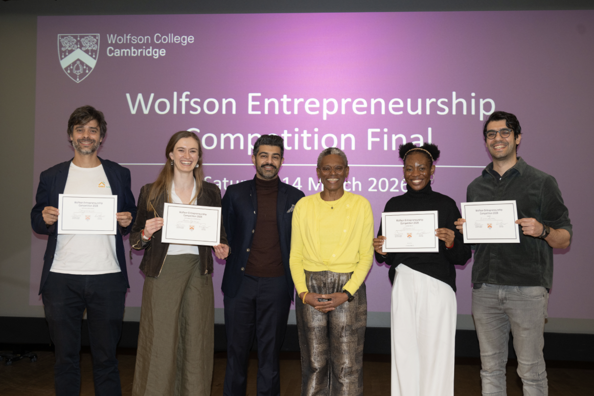 Afromics team on stage at the Wolfson Entrepreneurship Competition Final at Wolfson College, Cambridge